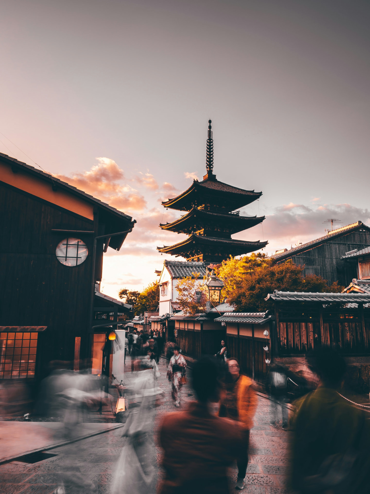 Traditional Kyoto lane at sunset with the Yasaka pagoda in the background