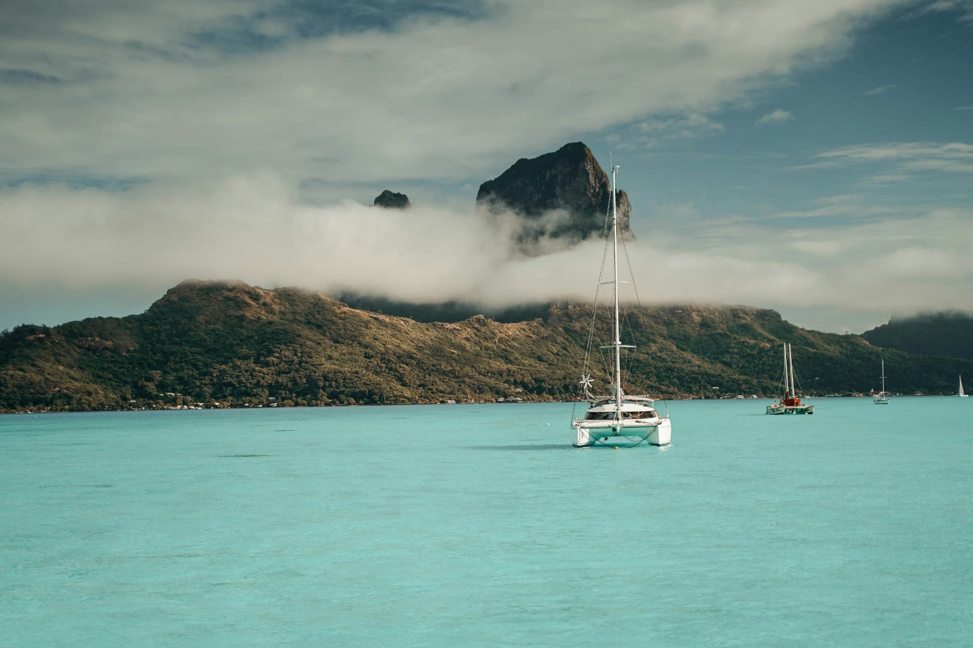 Catamaran anchored in the turquoise lagoon of Bora Bora, French Polynesia